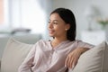 Happy relaxed African American homeowner resting on comfortable couch Royalty Free Stock Photo