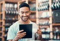 Happy, relaxed and carefree man reading social media news on a tablet while enjoying coffee. Young casual guy replying Royalty Free Stock Photo