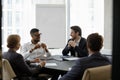 Happy relaxed multiracial business people talking in boardroom. Royalty Free Stock Photo