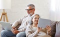 Happy relaxed old retired family couple using modern technologies laptop and digital tablet at home Royalty Free Stock Photo