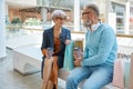 Happy relaxed senior couple spending time at shopping mall Royalty Free Stock Photo