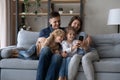 Happy relaxed family using cellphone apps at home. Royalty Free Stock Photo