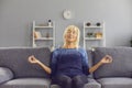 Happy relaxed senior woman practising meditation and stress relief exercise at home Royalty Free Stock Photo