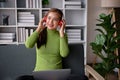 Happy and relaxed young Asian woman listening to music through her headphones Royalty Free Stock Photo