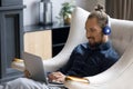 Happy relaxed young man in headphones using computer. Royalty Free Stock Photo