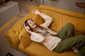 Happy relaxed young woman listening music in headphones at home Royalty Free Stock Photo