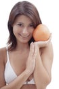 Happy relaxing girl with an orange fruit Royalty Free Stock Photo