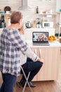 Happy remote daughter and niece talking with granparents using webcam Royalty Free Stock Photo