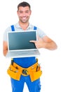 Happy repairman pointing at laptop Royalty Free Stock Photo