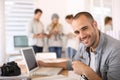 Happy reporter using laptop at office