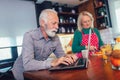 Happy senior couple browsing the internet together on a laptop computer Royalty Free Stock Photo