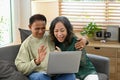 Happy retired couple having fun web surfing internet or making video call with family or friends on laptop together at Royalty Free Stock Photo