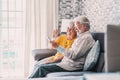 Happy retired family couple using mobile phone for video call together, talking to relations, getting good news, having fun, Royalty Free Stock Photo