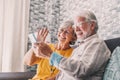 Happy retired family couple using mobile phone for video call together, talking to relations, getting good news, having fun, Royalty Free Stock Photo