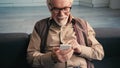 happy retired man in eyeglasses texting Royalty Free Stock Photo