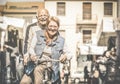 Happy retired senior couple having fun with bicycle at flea market Royalty Free Stock Photo