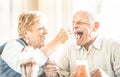 Happy retired senior couple in love enjoying bio icecream cup Royalty Free Stock Photo