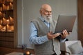 Happy retired senior man looking at laptop screen having videoconference Royalty Free Stock Photo