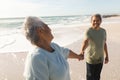 Happy retired senior multiracial couple holding hands while looking at each other on shore Royalty Free Stock Photo