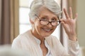 Senior woman holding eyeglasses Royalty Free Stock Photo