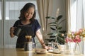 Happy retired woman preparing coffee for breakfast in home kitchen. Retirement, Healthy seniors lifestyle Royalty Free Stock Photo