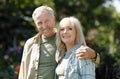 Happy retirement concept. Loving senior couple spending time in garden on sunny spring day Royalty Free Stock Photo