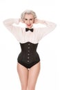 Happy retro girl with bow tie & corset, isolated on white