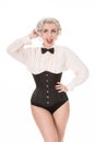 Happy retro girl with bow tie & corset, isolated on white