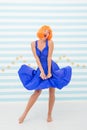 Happy retro woman with crazy look hold windy dress. crazy girl with happy face and orange hair. pin up girl in retro