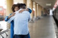 Happy Reunion. Joyful Black Woman Hugging Boyfriend At Railway Station After Arrival Royalty Free Stock Photo