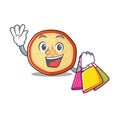 A happy rich apple chips waving and holding Shopping bag