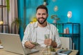 Happy rich business man counting money cash dividends salary and using laptop in home office Royalty Free Stock Photo