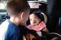 Happy road trip with young kid, Big brother and little sister playing together in car, Cute smiling Asian baby girl child sitting Royalty Free Stock Photo