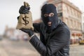 Happy robber is showing stolen bag full of money Royalty Free Stock Photo