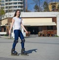 Happy Roller Girl skating in the park