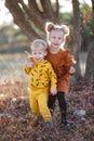Happy romantic children boy and girl play together in the autumn park on a warm evening at sunset Royalty Free Stock Photo