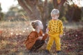 Happy romantic children boy and girl play together in the autumn park on a warm evening at sunset Royalty Free Stock Photo