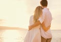 Happy romantic couple on the beach at sunset