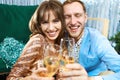Happy romantic couple clinking glasses with sparkling wine, enjoying evenrning party, having date at Valentine`s Day. Royalty Free Stock Photo
