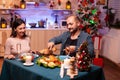 Happy romantic couple eating christmas dinner sitting at dinning table Royalty Free Stock Photo