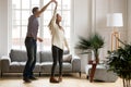 Happy romantic couple dancing in living room at home together Royalty Free Stock Photo