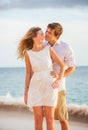Happy romantic couple kissing on the beach at sunset Royalty Free Stock Photo