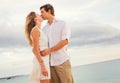 Happy romantic couple kissing on the beach at sunset Royalty Free Stock Photo