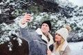 happy romantic couple making selfie outdoor in snowy winter