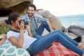 Happy and romantic couple, during a picnic on the rocks