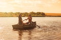 Happy romantic couple rowing a boat