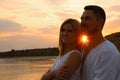 Happy romantic couple spending time together on beach at sunset Royalty Free Stock Photo