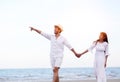 Happy Romantic Couples lover holding hands together walking on the beach Royalty Free Stock Photo