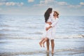 Happy Romantic Couples lover holding hands together walking on the beach