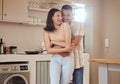 Happy, romantic and in love couple smiling, hugging and embracing while relaxing together indoors at home. Young, loving Royalty Free Stock Photo